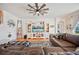 Cozy living room featuring a ceiling fan, tv console and plush leather couch at 5102 Pheasant Woods Dr, Lutz, FL 33558