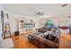 Bright living room featuring a ceiling fan, large windows and a plush leather couch at 5102 Pheasant Woods Dr, Lutz, FL 33558