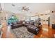 Spacious living room featuring a plush leather couch and large windows with a lake view at 5102 Pheasant Woods Dr, Lutz, FL 33558