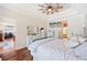 Stylish bedroom featuring hardwood floors, a ceiling fan and views into the dining area at 5102 Pheasant Woods Dr, Lutz, FL 33558
