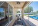 Covered patio featuring lake views, outdoor seating, string lights, a pool and a grill at 5102 Pheasant Woods Dr, Lutz, FL 33558