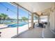 Enclosed patio featuring lake and pool views, string lights, and comfortable outdoor seating at 5102 Pheasant Woods Dr, Lutz, FL 33558