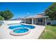 Outdoor pool and spa, with an outdoor kitchen on the screened-in lanai at 5102 Pheasant Woods Dr, Lutz, FL 33558