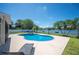 Beautiful kidney-shaped pool and spa overlook the lake in this home's backyard at 5102 Pheasant Woods Dr, Lutz, FL 33558