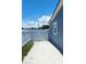 A fenced backyard features a concrete patio and the side of a light blue home at 5106 Town N Country Blvd, Tampa, FL 33615