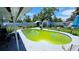 Backyard with a green pool and a view of the surrounding houses at 5106 Town N Country Blvd, Tampa, FL 33615