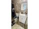 Bathroom with tiled walls, toilet with fun seat cover, and a vanity with modern sink and fixtures at 5106 Town N Country Blvd, Tampa, FL 33615