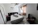 Bedroom with neutral walls, tiled floors, window with curtains, and a ceiling fan at 5106 Town N Country Blvd, Tampa, FL 33615