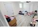 This bedroom has white walls and gray wood laminate flooring at 5106 Town N Country Blvd, Tampa, FL 33615