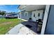 Charming gray home with a covered porch and double front doors at 5106 Town N Country Blvd, Tampa, FL 33615
