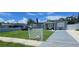 Charming gray home featuring a well-manicured lawn and white picket fence at 5106 Town N Country Blvd, Tampa, FL 33615