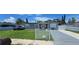 Charming gray home featuring a well-manicured lawn and white picket fence at 5106 Town N Country Blvd, Tampa, FL 33615