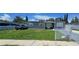 Charming gray home featuring a well-manicured lawn and white picket fence at 5106 Town N Country Blvd, Tampa, FL 33615
