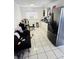 A black couch sits in the kitchen with the LG fridge visible at 5106 Town N Country Blvd, Tampa, FL 33615