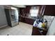 Spacious kitchen featuring stainless steel appliances, dark wood cabinets, and tiled backsplash at 5106 Town N Country Blvd, Tampa, FL 33615