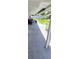 Covered patio overlooking a green pool surrounded by a fence and some trees at 5106 Town N Country Blvd, Tampa, FL 33615