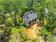 Aerial view of the charming home nestled among lush trees in a vibrant neighborhood at 5518 21St S Ave, Gulfport, FL 33707