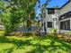Exterior view of the home with a large deck, lush landscaping, and a well-manicured lawn at 5518 21St S Ave, Gulfport, FL 33707
