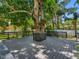 Large backyard deck with a mature tree growing in the center and wooden railings around the perimeter at 5518 21St S Ave, Gulfport, FL 33707