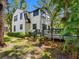 Backyard of a charming home featuring a wooden deck, lush foliage, and meticulous landscaping at 5518 21St S Ave, Gulfport, FL 33707