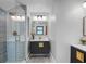 Modern bathroom with a glass shower, vanity with a brass faucet, and neutral decor at 5518 21St S Ave, Gulfport, FL 33707