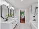 Bathroom featuring a double vanity with black fixtures, white cabinets and a walk-in shower at 5518 21St S Ave, Gulfport, FL 33707