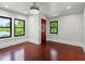 Bedroom featuring dark hardwood floors, lots of natural light and a decorative light fixture at 5518 21St S Ave, Gulfport, FL 33707
