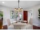 Dining room features glass table, comfortable chairs, chandelier, and modern artwork at 5518 21St S Ave, Gulfport, FL 33707