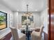 Elegant dining room with a glass table, stylish chandelier, and hardwood floors at 5518 21St S Ave, Gulfport, FL 33707