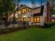 Charming two-story home with deck, green lawn, mature trees, and manicured flower beds at 5518 21St S Ave, Gulfport, FL 33707