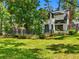 Exterior view of the home with a large deck, lush landscaping, and a well-manicured lawn at 5518 21St S Ave, Gulfport, FL 33707