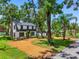 Charming two-story home featuring a manicured lawn and beautiful landscaping on a sunny day at 5518 21St S Ave, Gulfport, FL 33707