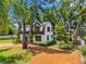 Beautiful landscaped home surrounded by mature trees featuring a new roof and lush landscaping at 5518 21St S Ave, Gulfport, FL 33707