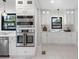 Modern white kitchen featuring built-in oven, updated appliances, and stylish light fixtures at 5518 21St S Ave, Gulfport, FL 33707