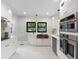 Bright kitchen with stainless steel appliances, modern cabinetry, white counters, and hardwood floors at 5518 21St S Ave, Gulfport, FL 33707