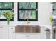 Close-up of a stylish copper kitchen sink with modern faucet and bright natural light at 5518 21St S Ave, Gulfport, FL 33707