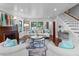 Bright living room with hardwood floors, fireplace, staircase, and modern furniture at 5518 21St S Ave, Gulfport, FL 33707