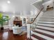 Bright living room with fireplace, hardwood floors, and staircase with white spindles at 5518 21St S Ave, Gulfport, FL 33707