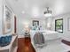 Bedroom with hardwood floors, crystal chandelier, and a well-appointed, comfortable bed at 5518 21St S Ave, Gulfport, FL 33707
