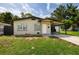 Cozy single-story home with a convenient covered carport and well-kept lawn at 5519 Kelly N Dr, St Petersburg, FL 33703