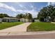 Charming single-story home with a well-maintained front yard and long concrete driveway at 5519 Kelly N Dr, St Petersburg, FL 33703