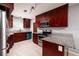 Well-equipped kitchen featuring granite countertops and cherry cabinets at 5519 Kelly N Dr, St Petersburg, FL 33703