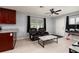 Open-concept living room with tile floors, ceiling fan, and leather recliners at 5519 Kelly N Dr, St Petersburg, FL 33703