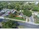 Aerial view showcasing a fenced property with a well-maintained lawn and ample parking at 5651 6Th St, Zephyrhills, FL 33542