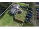 Aerial view showcasing the home, solar panels, expansive yard, and ample parking at 5651 6Th St, Zephyrhills, FL 33542