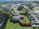 Aerial view of a property with a fenced backyard, solar panels, and surrounding neighborhood at 5651 6Th St, Zephyrhills, FL 33542