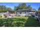 Spacious backyard with a gazebo-covered hot tub, green lawn, and solar panels at 5651 6Th St, Zephyrhills, FL 33542