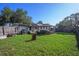 Large, fenced backyard featuring a gazebo with hot tub and well-maintained lawn at 5651 6Th St, Zephyrhills, FL 33542
