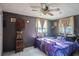 Cozy bedroom with a ceiling fan, curtains and unique decor at 5651 6Th St, Zephyrhills, FL 33542