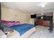 Simple bedroom featuring tile floors, tv, and closet space at 5651 6Th St, Zephyrhills, FL 33542